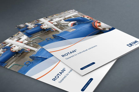 DESMI brochurer med ROTAN pumper til industriel væskehåndtering på en grå overflade.